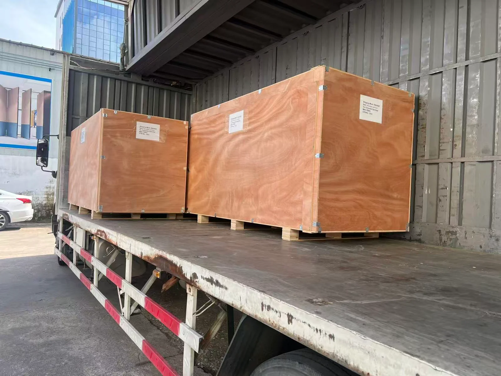 First-party EBUNGE plywood export crates loaded on a delivery truck