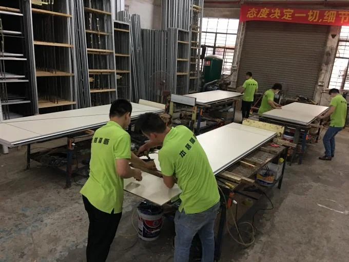 EBUNGE team assembling partition panels in the production workshop