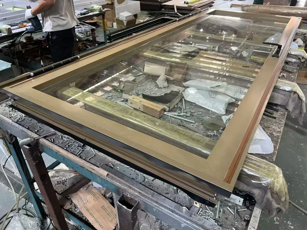 Real EBUNGE framed glass partition panel during workshop assembly
