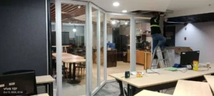 Real office glass partition installation in progress